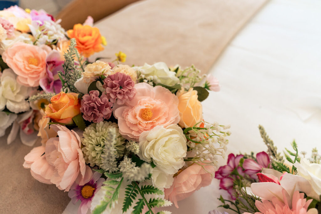 Bridal bouquet of peach roses and wildflowers at Tournerbury Woods Estate, Hayling Island