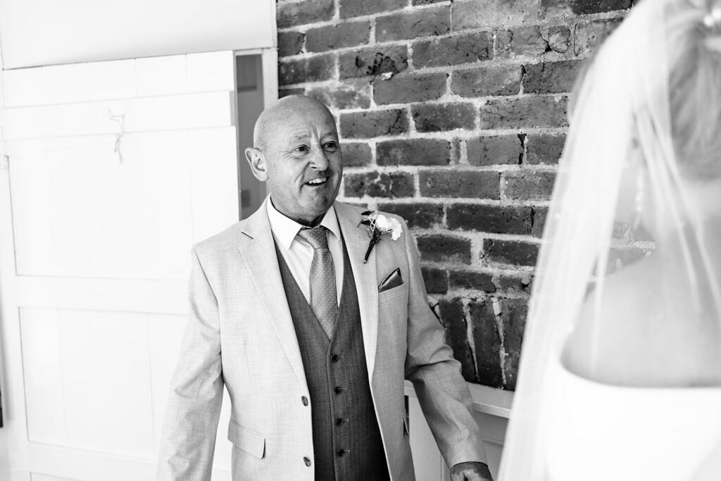 Dad seeing the bride for the first time, black and white at Tournerbury Woods Estate, Hayling Island