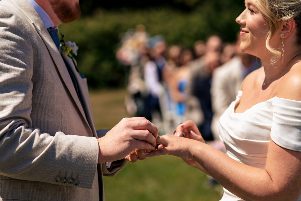Exchanging rings at the outdoor ceremony at Tournerbury Woods Estate, Hayling Island