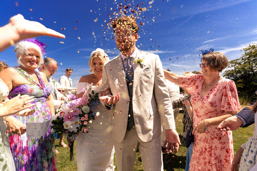 Confetti exit with guests cheering at Tournerbury Woods Estate, Hayling Island