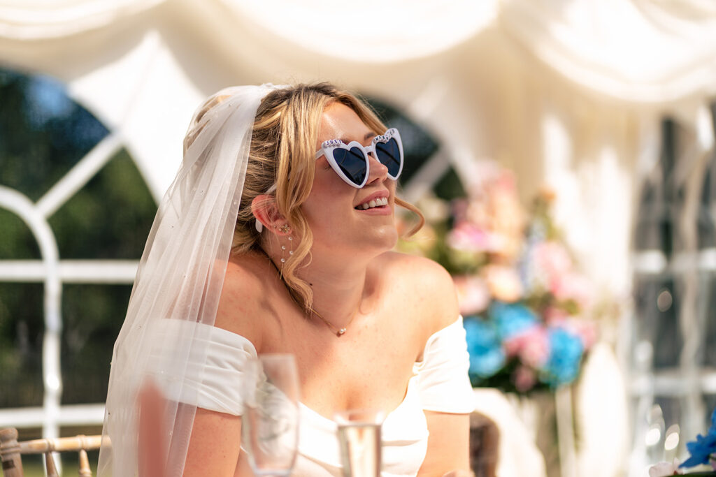 Bride laughing in the marquee at Tournerbury Woods Estate, Hayling Island