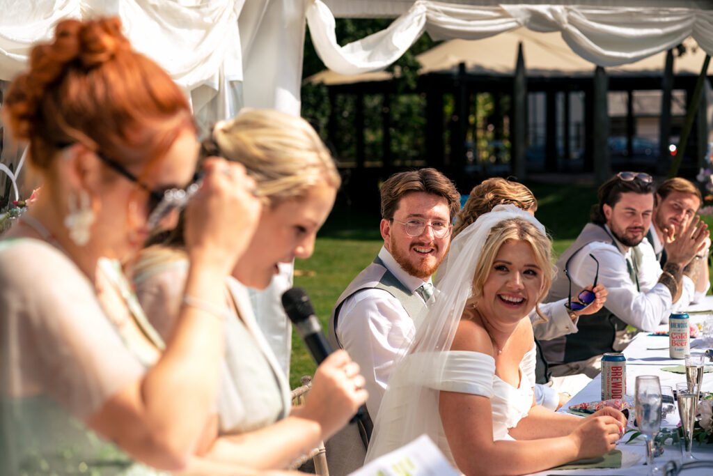 Guests laughing during the speeches at Tournerbury Woods Estate, Hayling Island