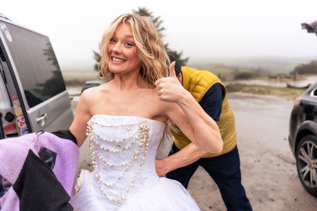 Model laughing in the rain at Butser Hill, Wuthering Heights styled shoot