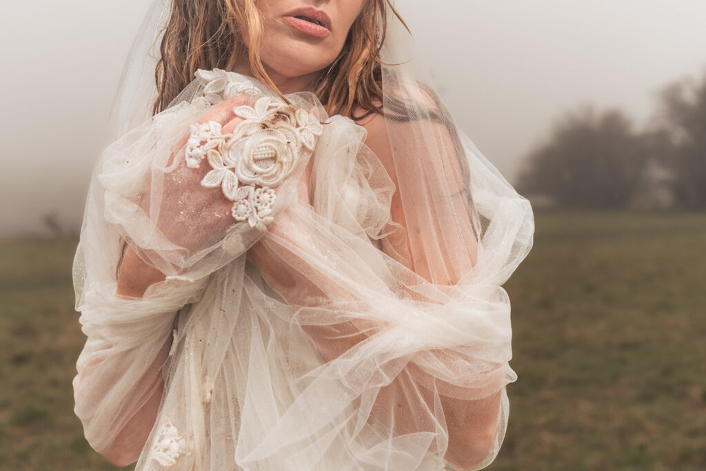 Hands holding the veil at Butser Hill, Wuthering Heights styled shoot