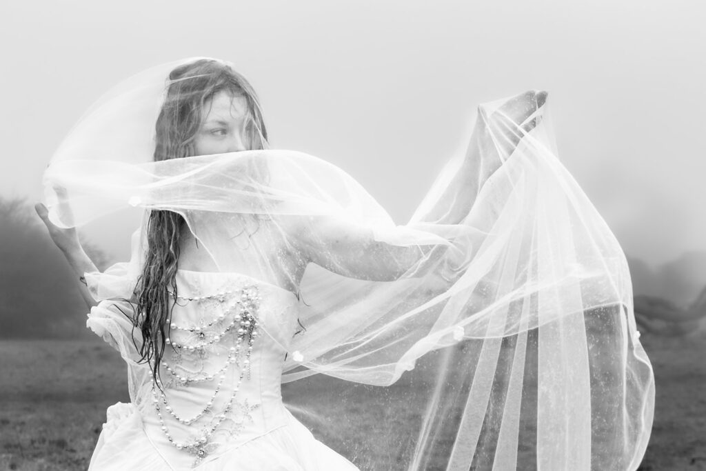 Veil billowing in the wind at Butser Hill, Wuthering Heights styled shoot